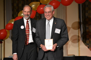 Two men accepting awards