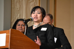 Woman speaking behind a podium